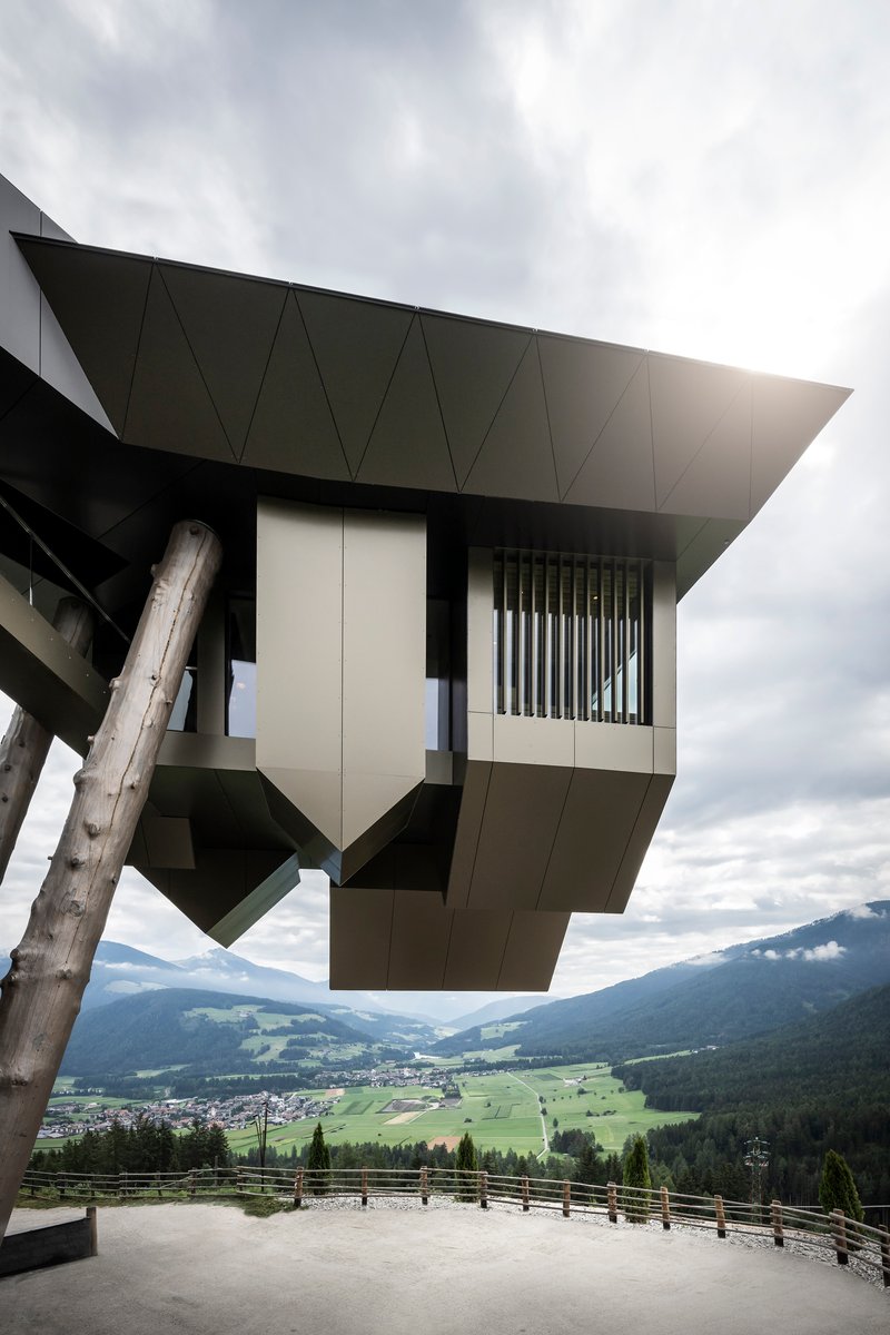 Underside view of the angular cantilever with vertical louvers overlooking a valley below