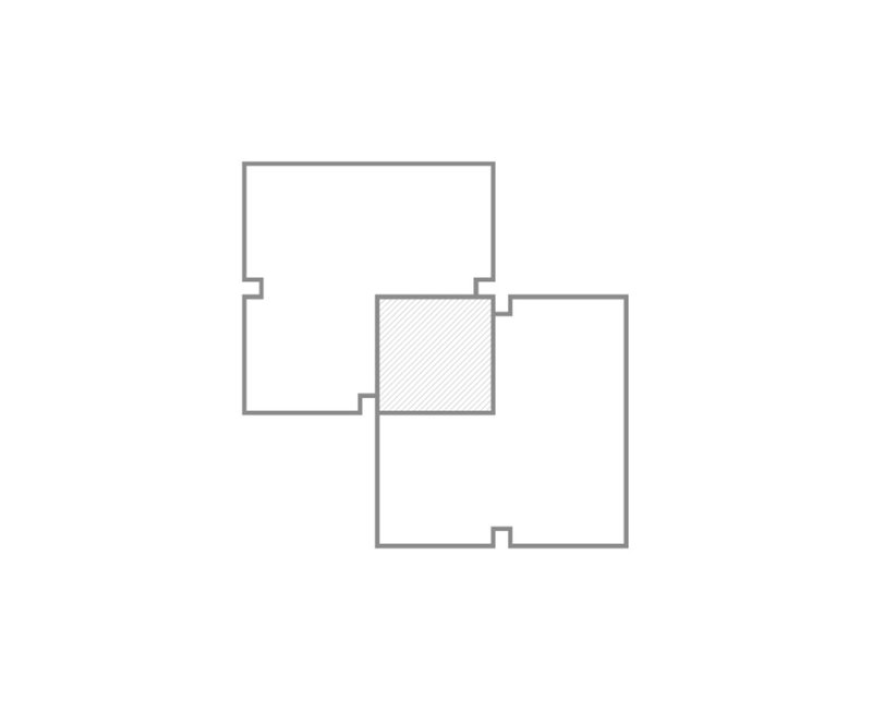 Floor plan drawing showing four rectangular volumes arranged around a central hatched square