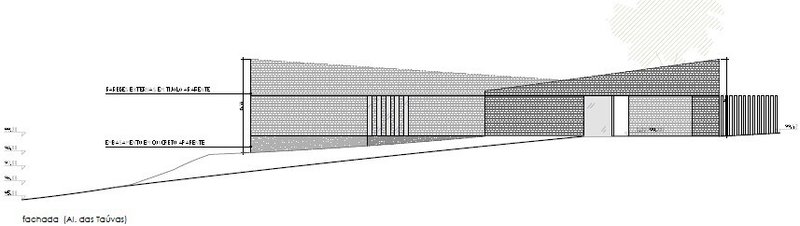 Elevation drawing showing the long brick facade on a sloping grade with vertical window bays