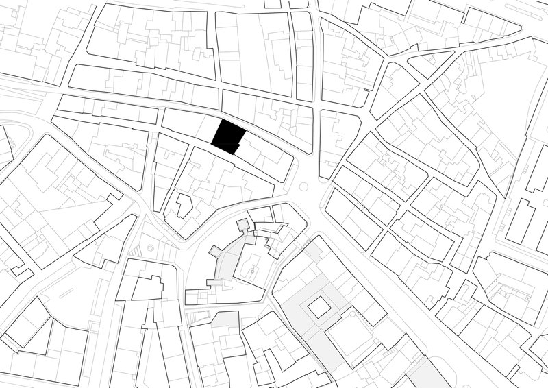Site plan drawing showing a single highlighted building footprint within the surrounding urban fabric