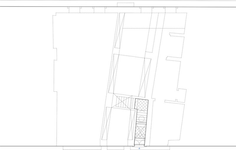 Floor plan drawing showing an angular layout with stairs and courtyard spaces