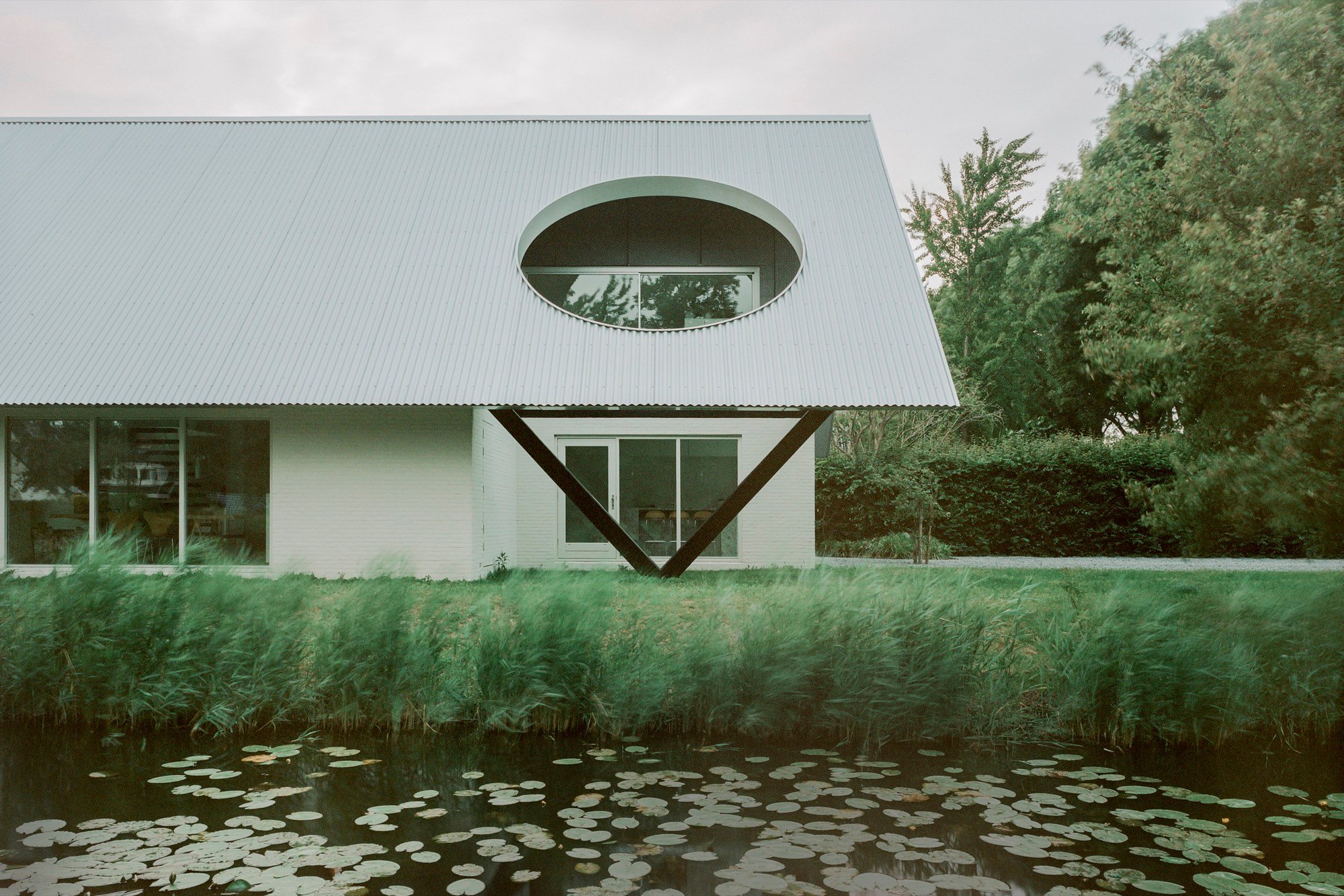 Space Encounters Crowns a 1980s Dutch House with Corrugated Aluminum and Geometric Apertures