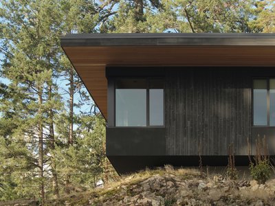 W O V E N Architecture Cantilevers a Charred Timber Retreat Over Salt Spring Island's Rocky Shore