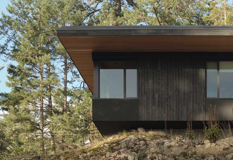 W O V E N Architecture Cantilevers a Charred Timber Retreat Over Salt Spring Island's Rocky Shore
