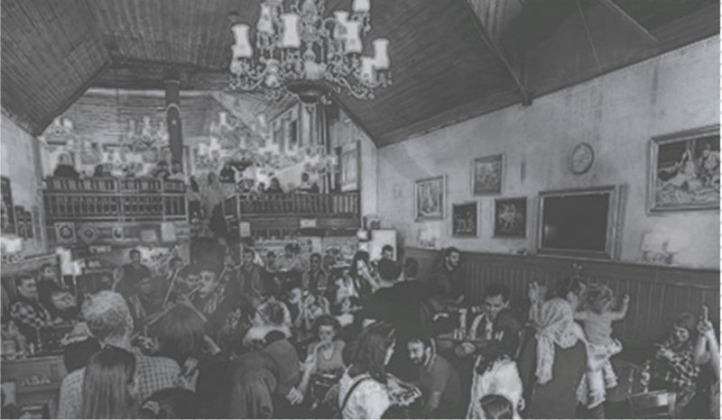 A vibrant heritage coffee house where communal gathering, ornament, and cultural exchange shape the interior atmosphere.