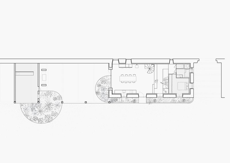 Floor plan drawing of a narrow volume with dining area, courtyard, and planted beds along the perimeter