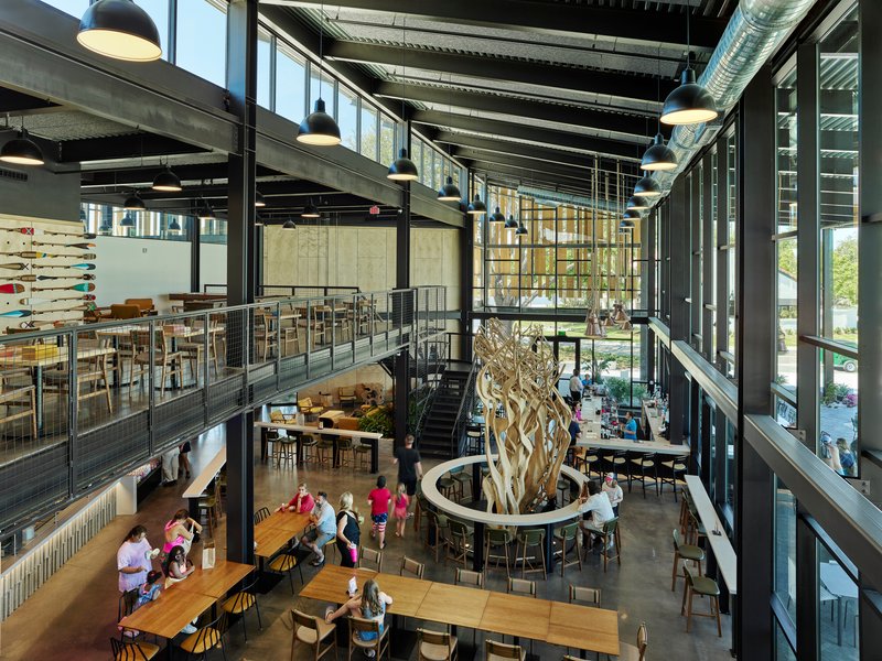 Mezzanine view of the multi-level dining space with exposed ductwork and diners gathered below