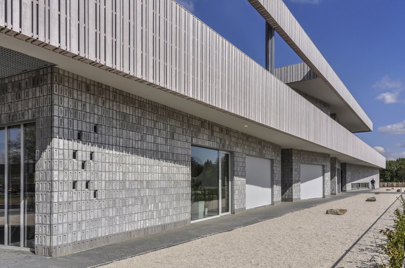 Patterned masonry and horizontal volumes define the school’s digital architectural identity.