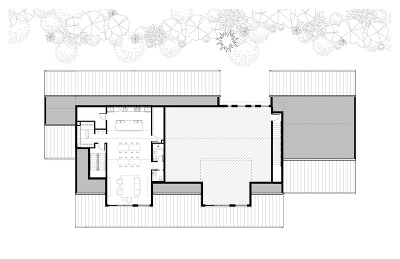 Floor plan drawing showing the upper level with open central space flanked by smaller rooms and deck