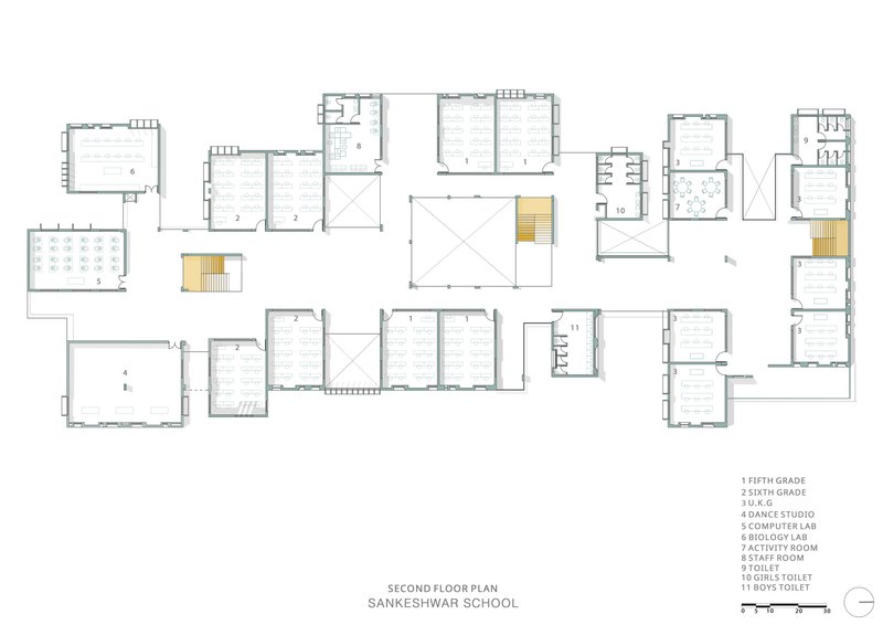Second floor plan drawing illustrating classroom blocks arranged around a central void with staircases in yellow