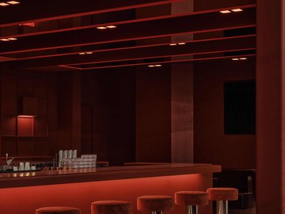 Ivy Studio Splits a Montreal Industrial Shell into a Burgundy Lounge and a Beige Padel Arena