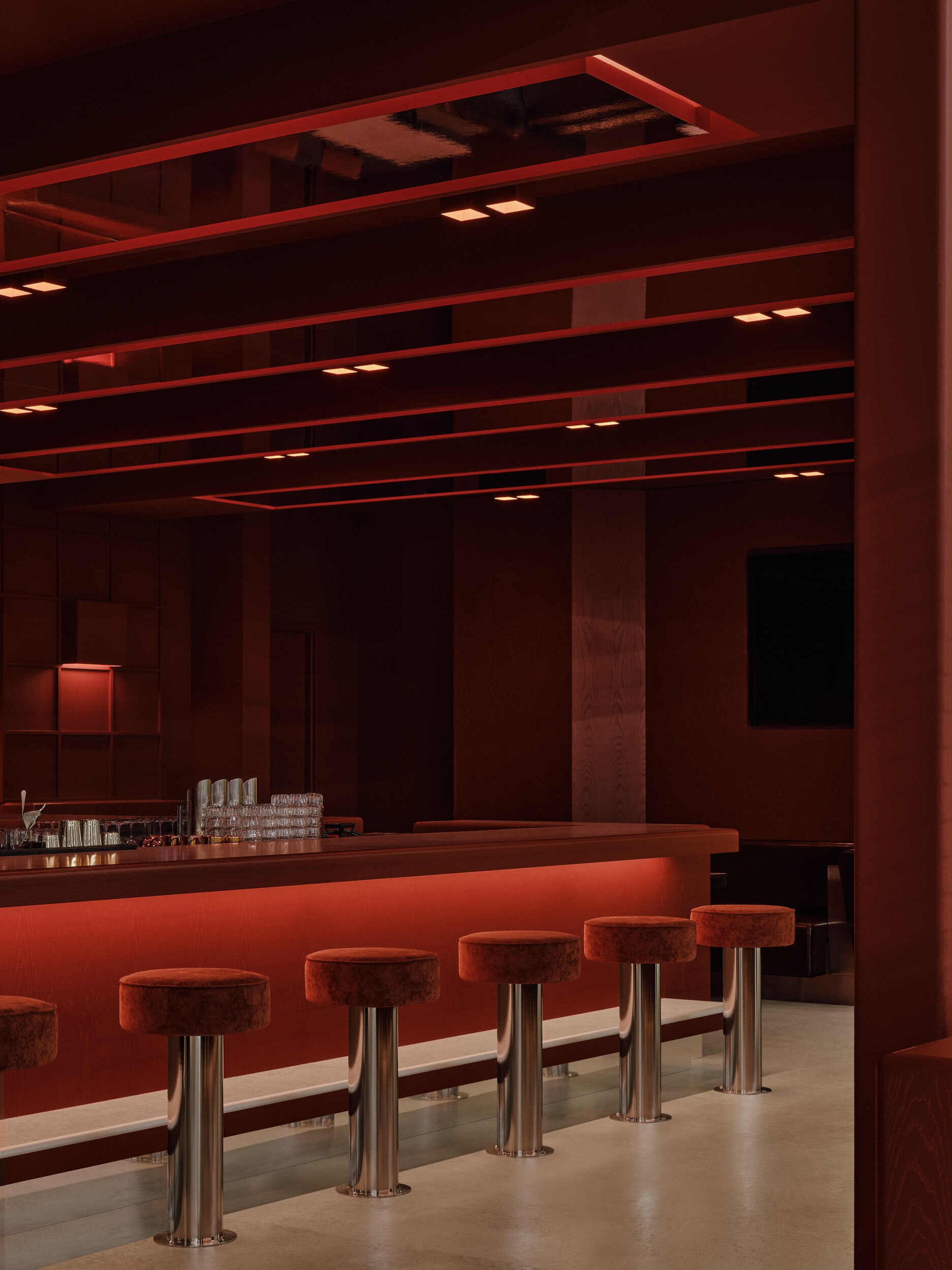 Ivy Studio Splits a Montreal Industrial Shell into a Burgundy Lounge and a Beige Padel Arena