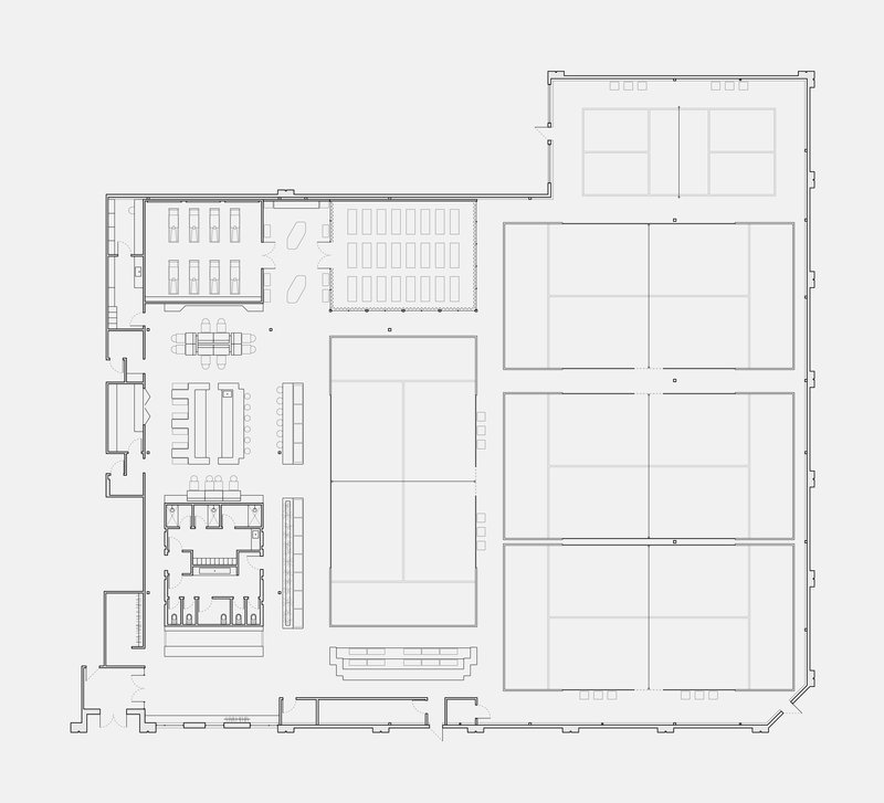 Floor plan showing a large open seating area flanked by service spaces and courtyard volumes