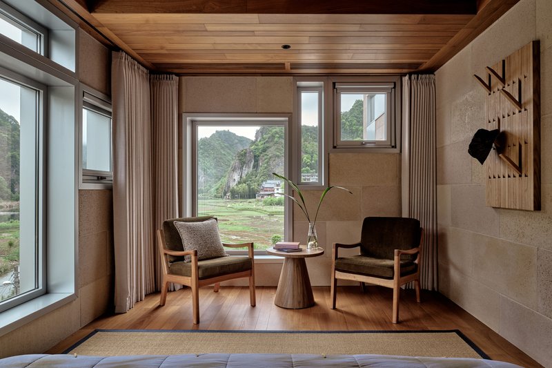 Corner seating nook with timber flooring and multiple windows looking toward the valley landscape