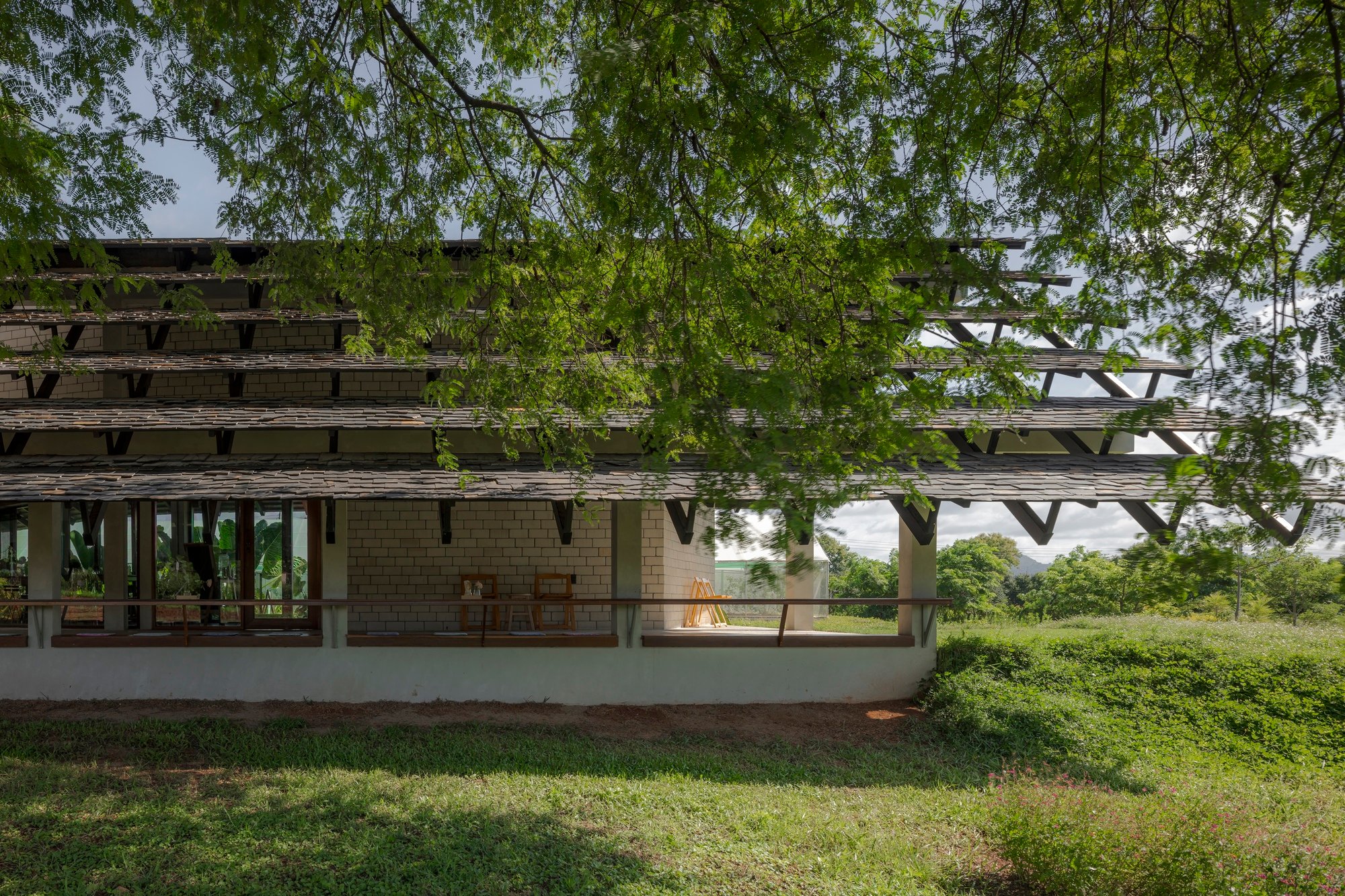 SO Splits a Gable Roof in Two to Let a Tamarind Canopy Define a Thai Farmshop