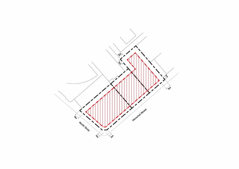 Site plan drawing showing two rectangular building footprints with hatched fill on a corner lot