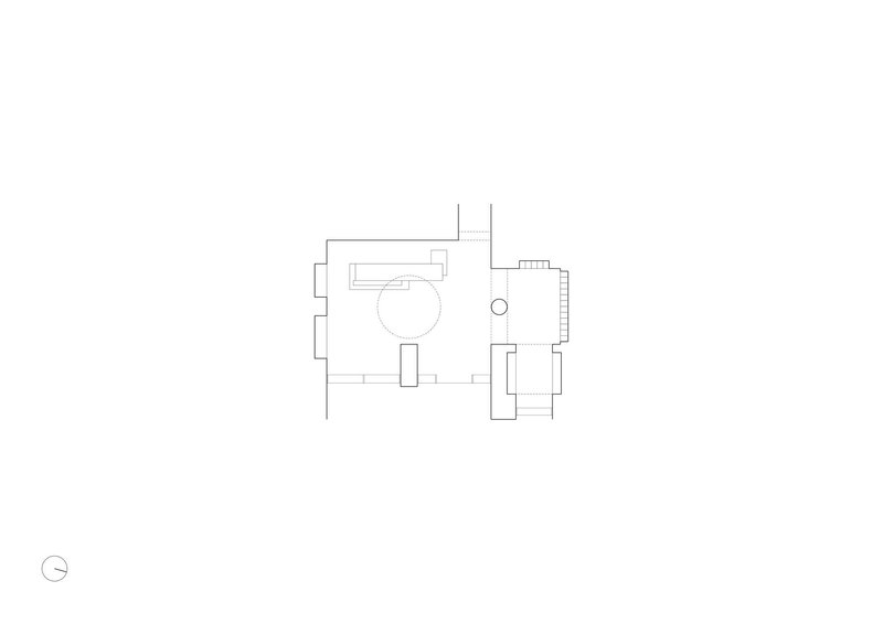 Floor plan drawing showing two connected rooms with circular element and north arrow indicator
