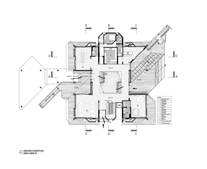 Ground floor plan drawing showing rooms arranged around a central void with angled wing extensions