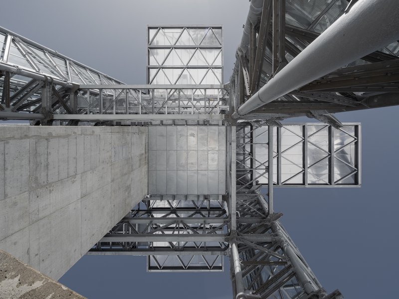 Upward view of the steel lattice structure with concrete base and triangulated glass panels
