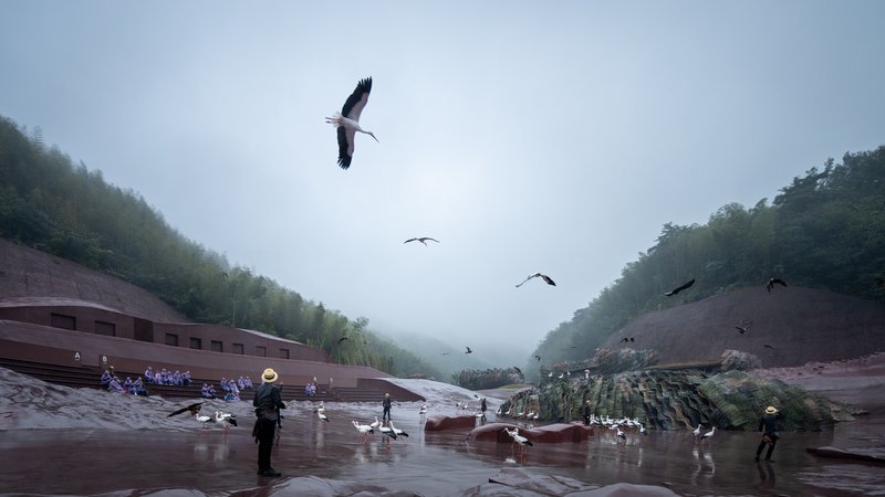 Sloped plaza with visitors and cranes amid flying ibises in heavy morning fog