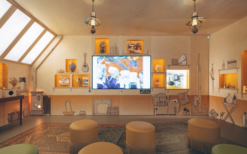 Gallery room with diagonal skylights, illuminated display niches and circular upholstered seating on a patterned rug