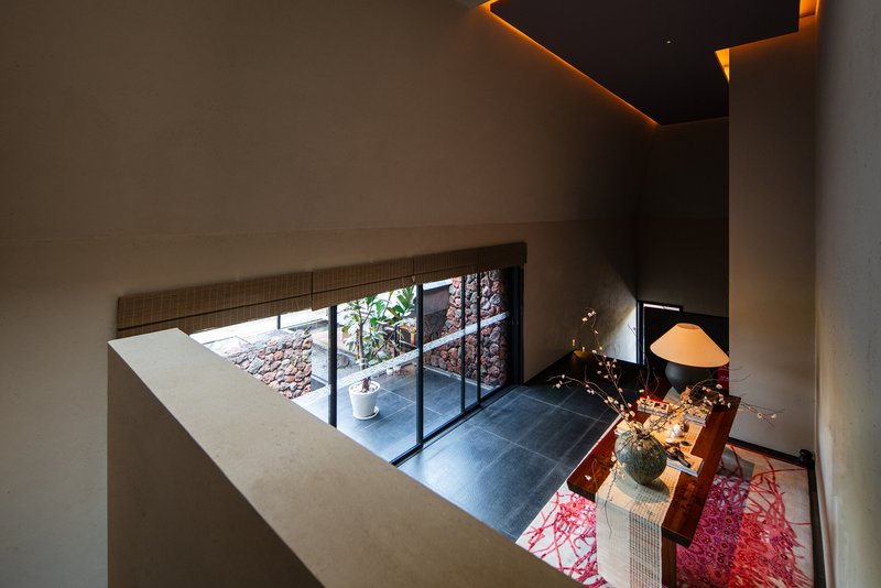 View down into the dining room from the upper landing with ambient ceiling lighting