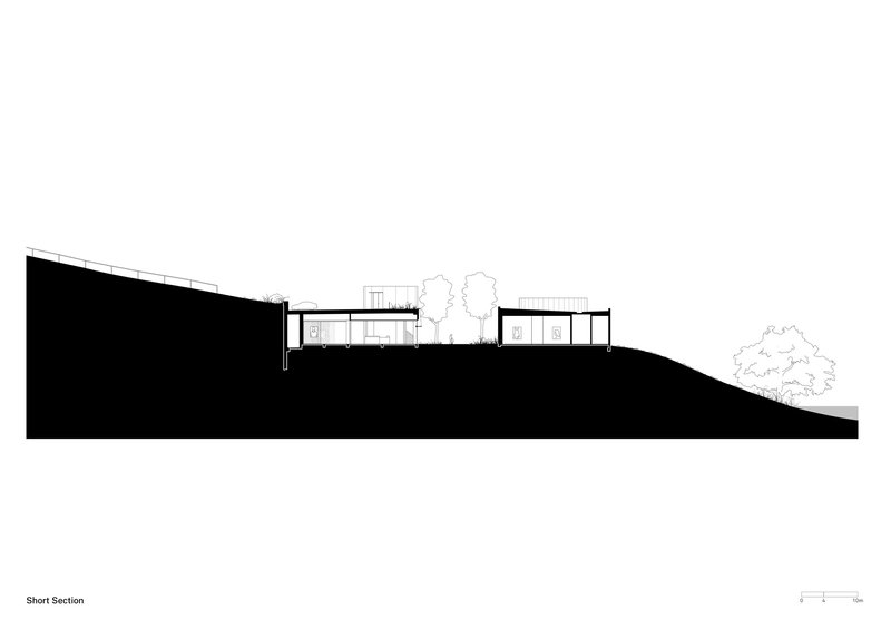 Short section drawing illustrating the building's relationship to sloping terrain and tree placement