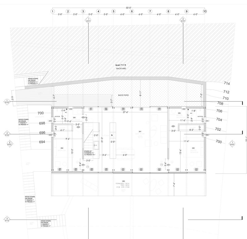 Floor plan drawing showing open living spaces with central core and adjacent patio