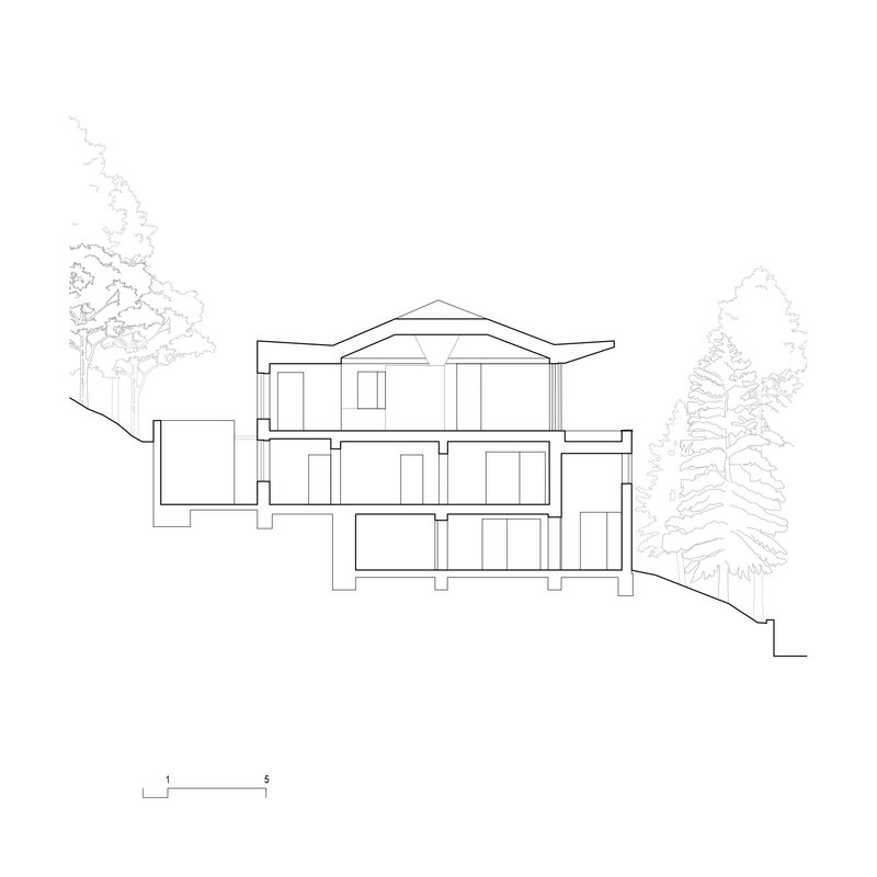 Section drawing through a three-level residence with gabled roof on descending slope with adjacent trees