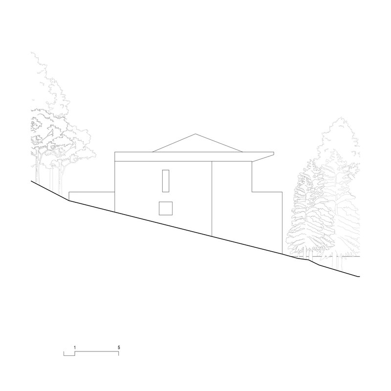 Elevation drawing of downslope facade showing minimal window openings and triangular roof with adjacent evergreen