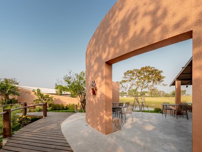 BodinChapa Architects Wraps a Rice-Grain Restaurant in Curved Brick on a Thai Paddy Field