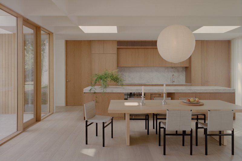 Dining area with timber cabinetry, stone countertop, and skylights above the table