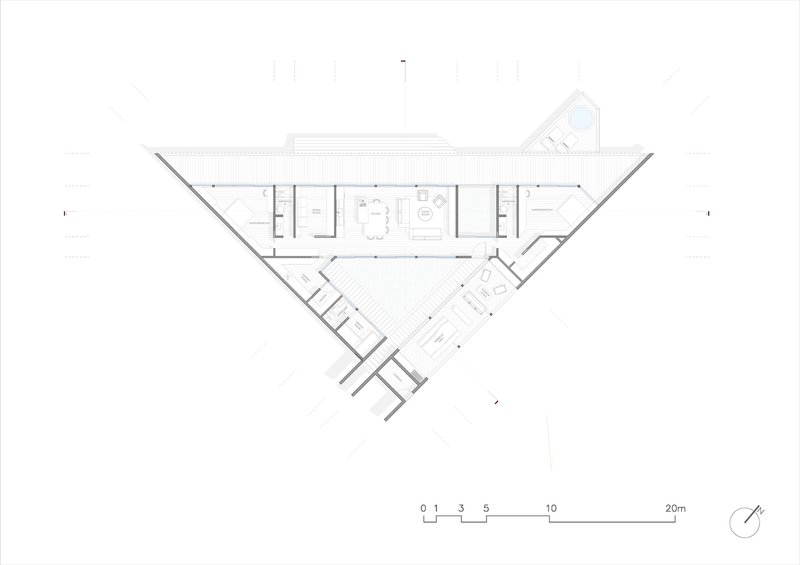 Floor plan drawing showing a linear central volume flanked by angled wings and service spaces