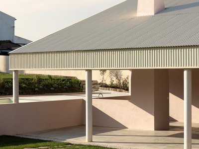 Vasco Burnay Wraps a Pink L-Shaped House in a Deep South-Facing Porch in Vila Franca de Xira
