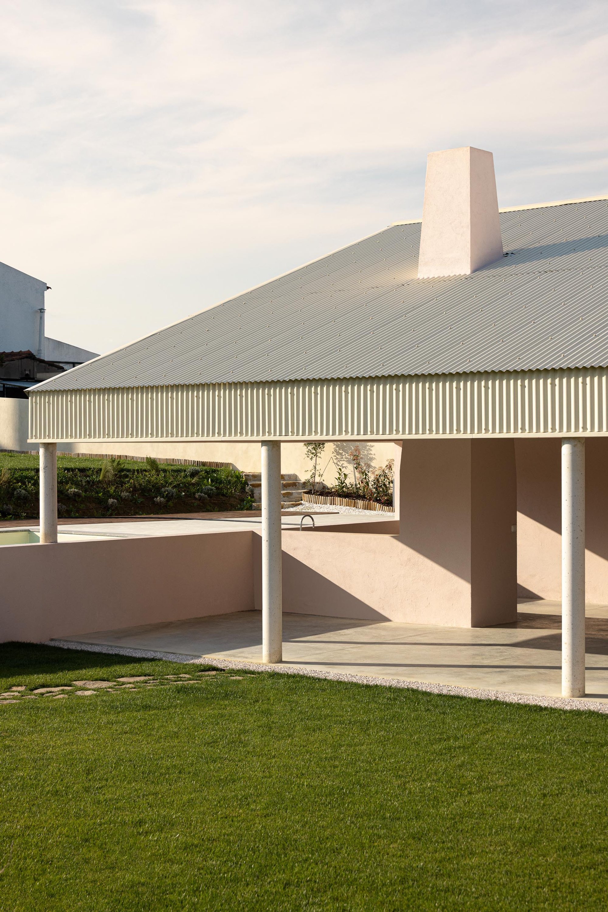 Vasco Burnay Wraps a Pink L-Shaped House in a Deep South-Facing Porch in Vila Franca de Xira