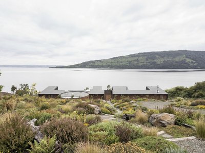Triangular Floats a Lake House on Point Supports Above Chile's Humid Volcanic Shore