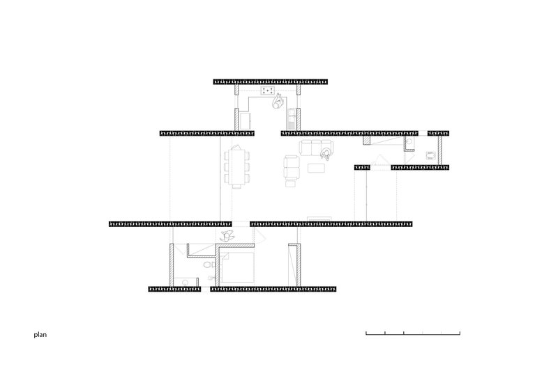 Floor plan drawing showing interconnected rectangular spaces with furniture layouts and openings