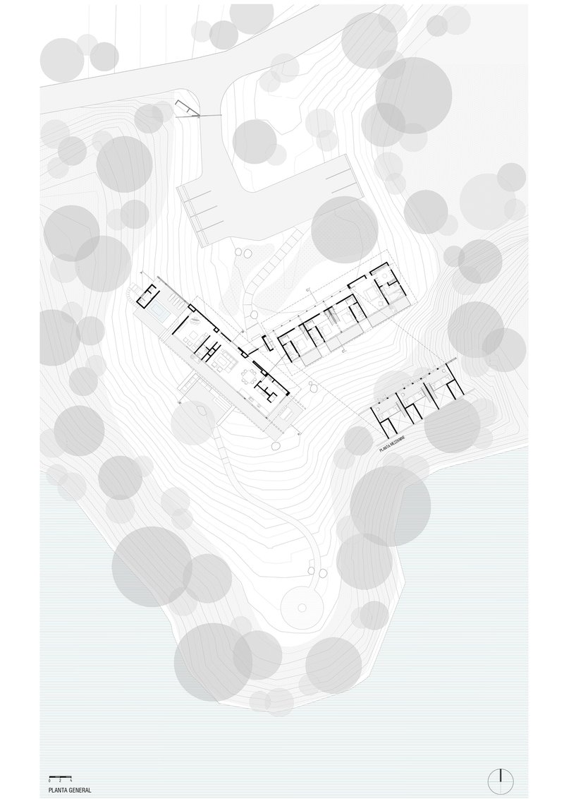 Floor plan drawing showing two linear wings with interior room divisions nestled in a wooded hillside