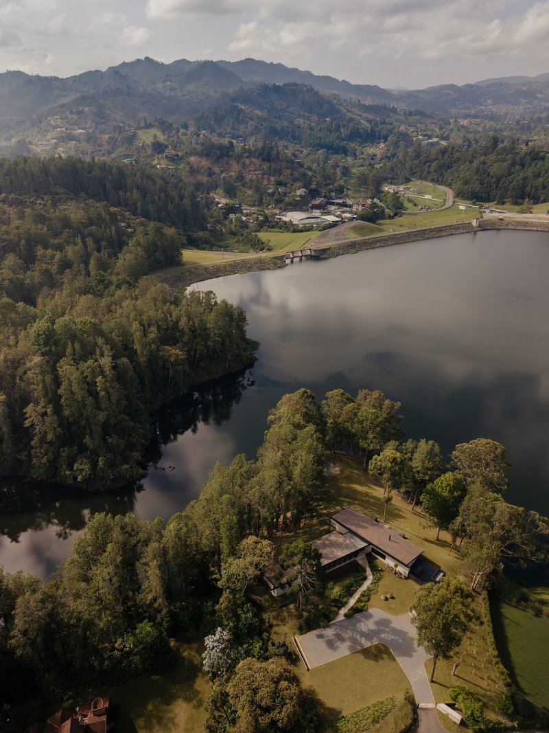 Obranegra Arquitectos Settles a Pine-Clad House onto a Reservoir Peninsula in the Colombian Highlands
