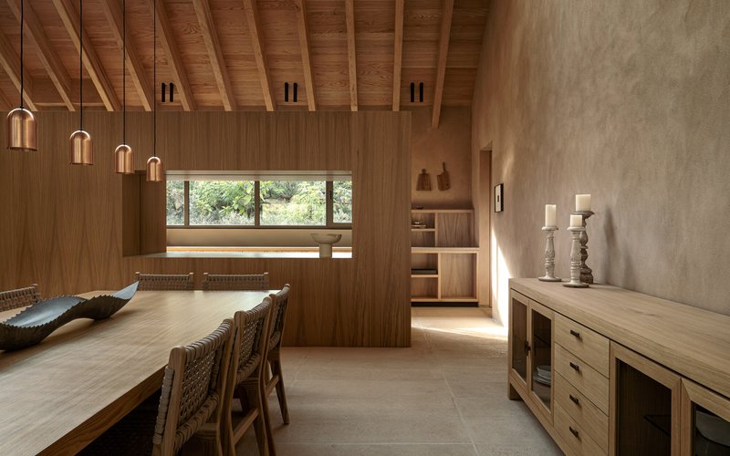 Timber-lined dining area with exposed ceiling joists and horizontal window framing distant trees