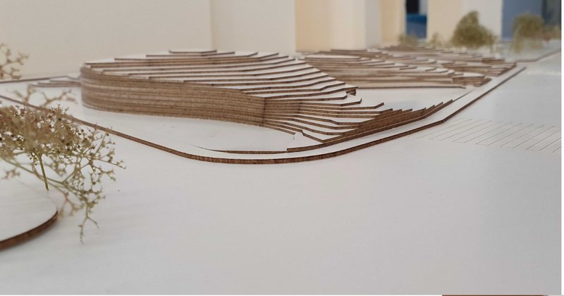 Landscape-integrated massing model showing the hillock form shaped by climate optimization.