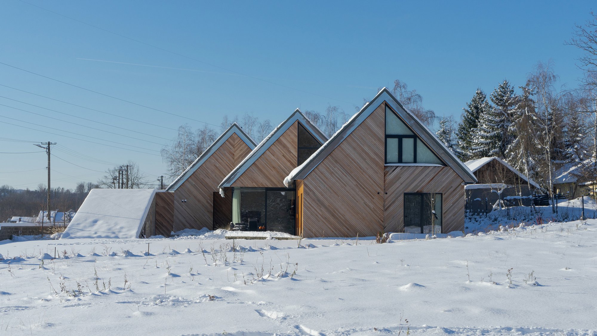 Triple House by Superhelix Pracownia Projektowa: A Harmonious Blend of Function, Form, and Landscape