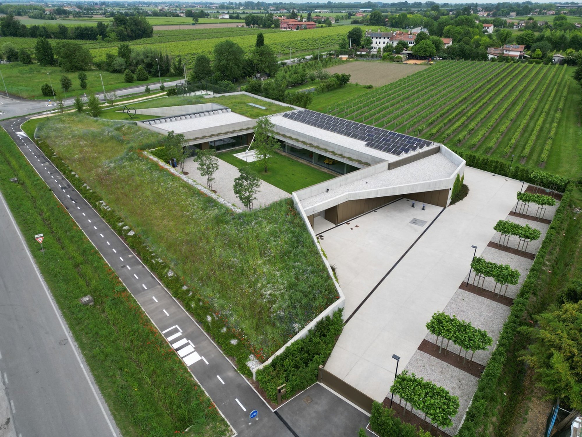 Orangeale Factory by C&P Architetti: A Harmonious Blend of Industrial Design and Natural Landscape