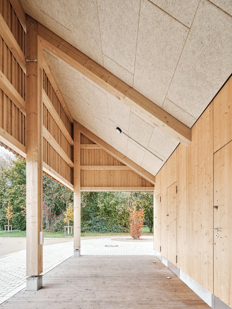 Covered exterior porch with timber columns, exposed rafters and hempcrete ceiling panels
