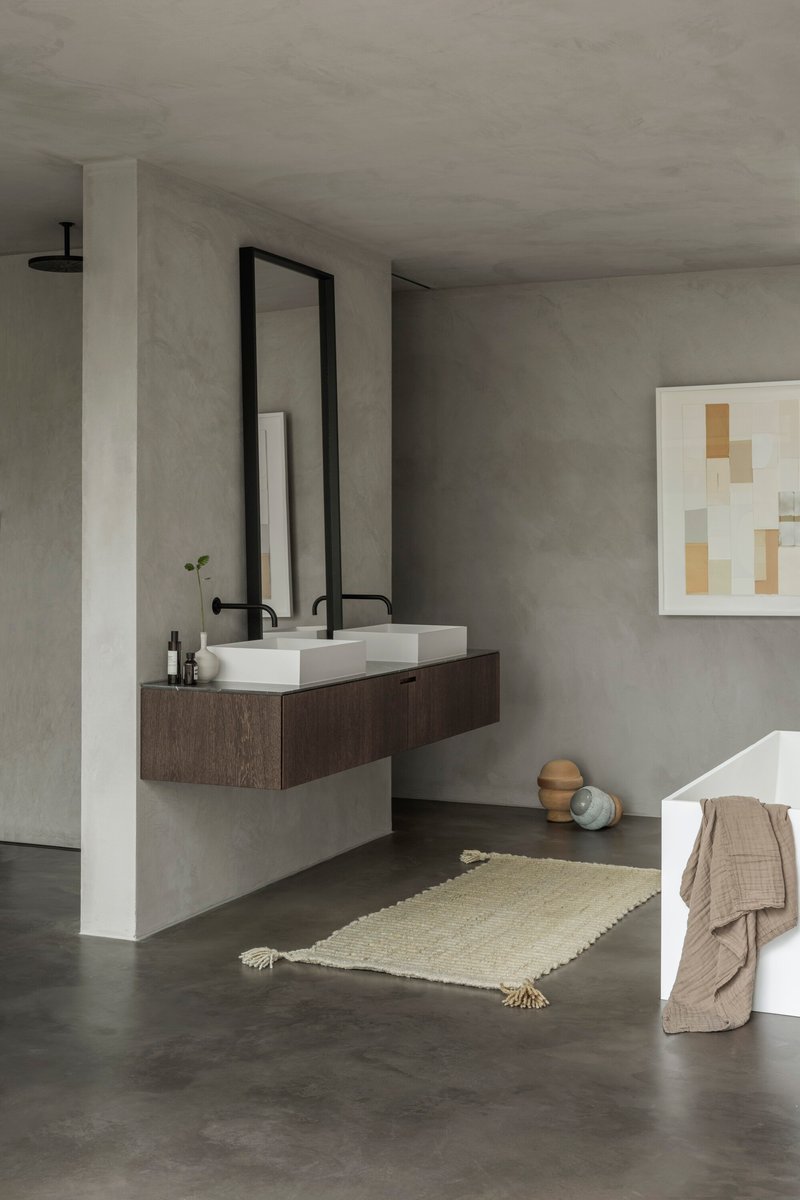 Bathroom with floating dark timber vanity and rectangular vessel sinks beneath a tall black-framed mirror