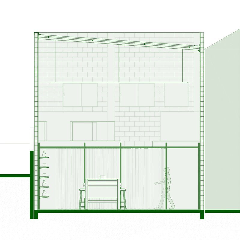 Section drawing showing vertical slat wall with built-in desk and shelving beside walking figure
