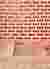 The image showcases a brick wall with a perforated design, creating a rhythmic pattern of openings. 
