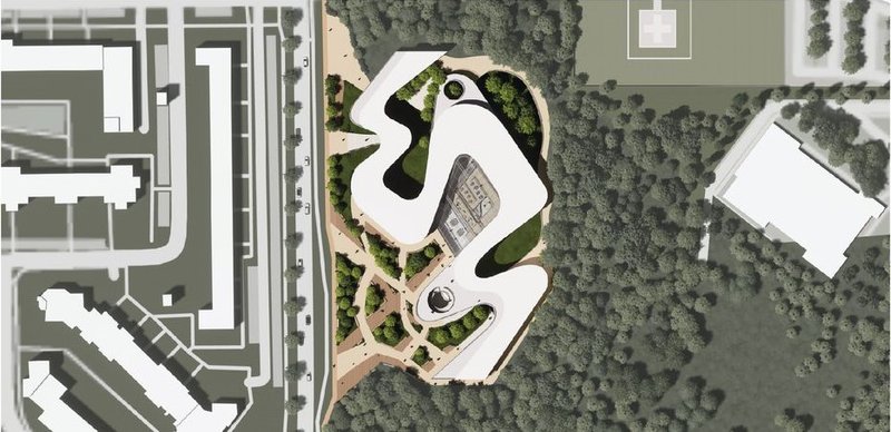 Aerial view of the serpentine library within urban greenery.
