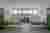 This image depicts a modern hospital room with a minimalist design. The room features two hospital b