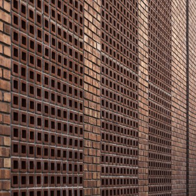 The image showcases a brick facade with a distinctive perforated pattern. The brickwork is arranged 